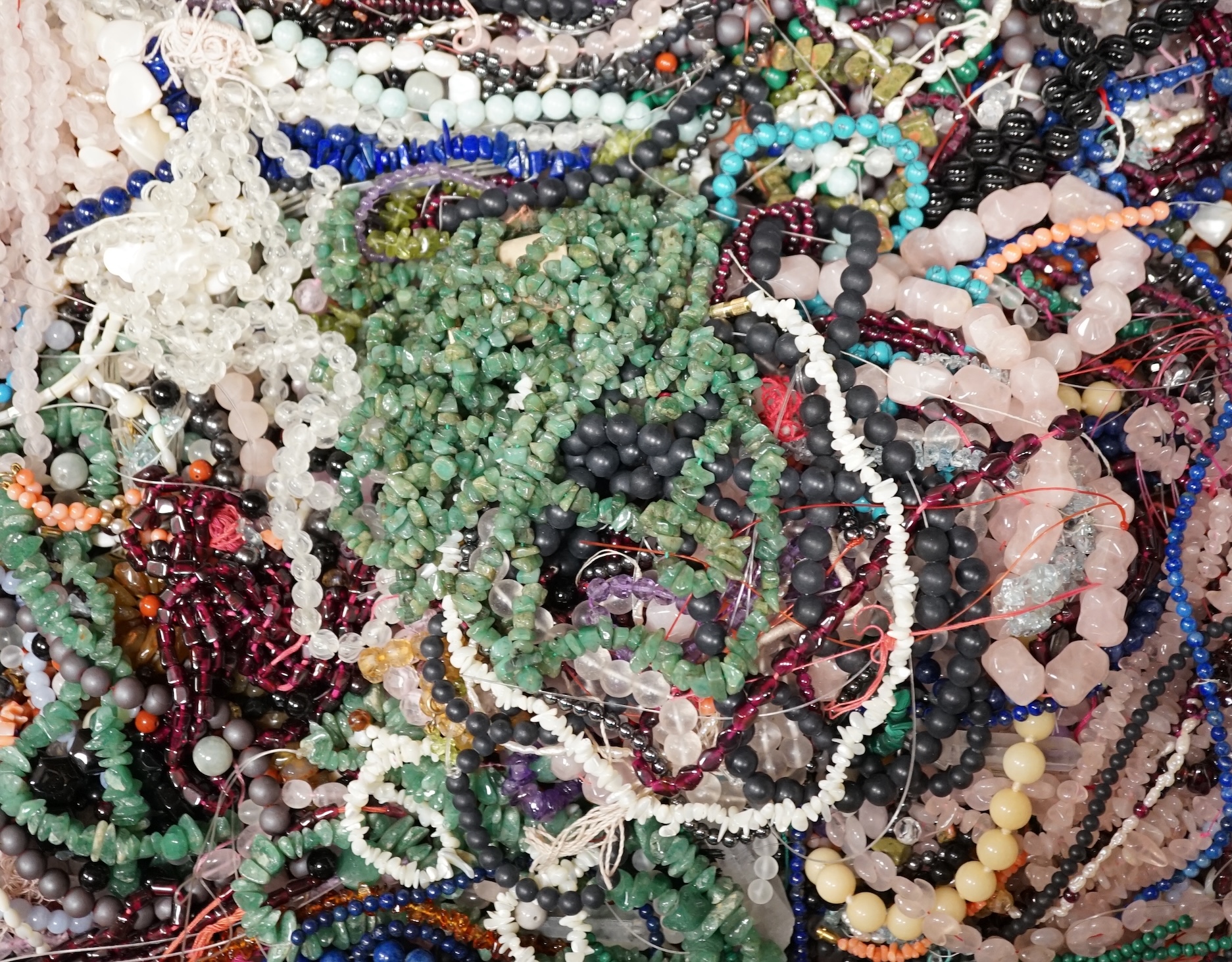 A large collection of in excess of three hundred bead necklaces and bracelets and a quantity of hardstone beads. Condition - poor to fair